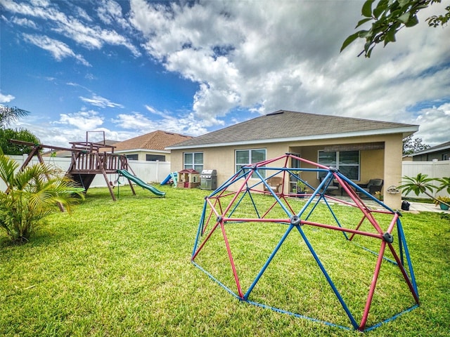 2731 Star Coral Ln, New Smyrna Beach, FL 32168 - rear view of property featuring a playground and stucco siding