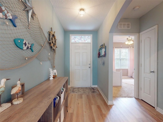 2731 Star Coral Ln, New Smyrna Beach, FL 32168 - foyer with light wood-style floors and arched walkways