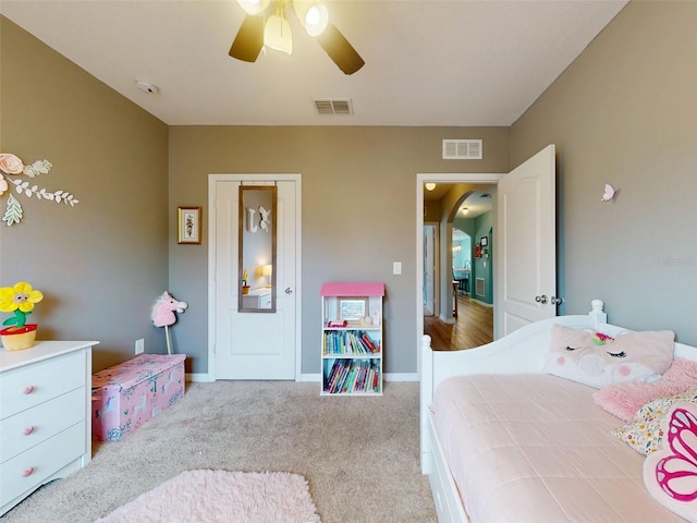2731 Star Coral Ln, New Smyrna Beach, FL 32168 - bedroom featuring arched walkways, carpet flooring, and a ceiling fan