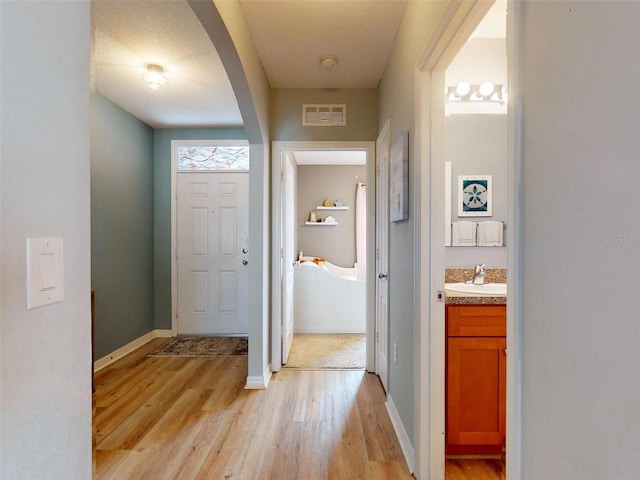 2731 Star Coral Ln, New Smyrna Beach, FL 32168 - foyer with arched walkways and light wood-style flooring