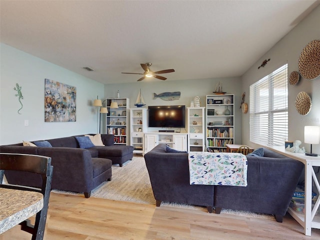 2731 Star Coral Ln, New Smyrna Beach, FL 32168 - living room featuring a ceiling fan and wood finished floors
