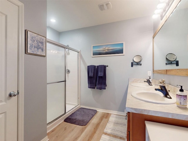 2731 Star Coral Ln, New Smyrna Beach, FL 32168 - bathroom with wood finished floors, double vanity, a stall shower, and recessed lighting