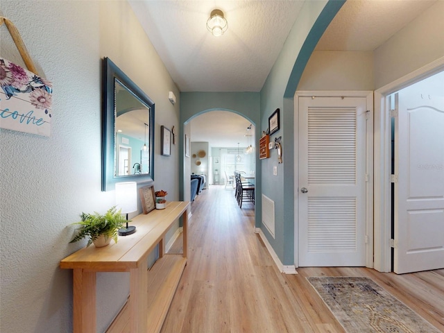 2731 Star Coral Ln, New Smyrna Beach, FL 32168 - hall with arched walkways and light wood finished floors