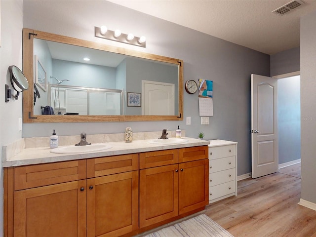 2731 Star Coral Ln, New Smyrna Beach, FL 32168 - full bathroom with a shower with door, double vanity, and wood finished floors