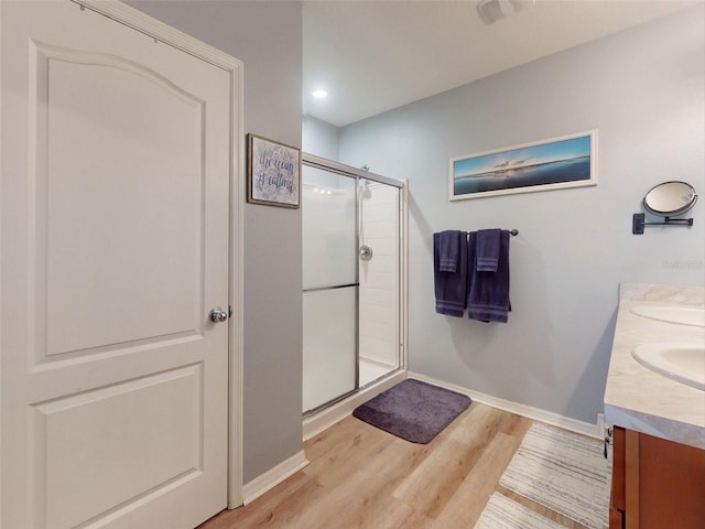 2731 Star Coral Ln, New Smyrna Beach, FL 32168 - full bath featuring wood finished floors, a shower stall, double vanity, and recessed lighting