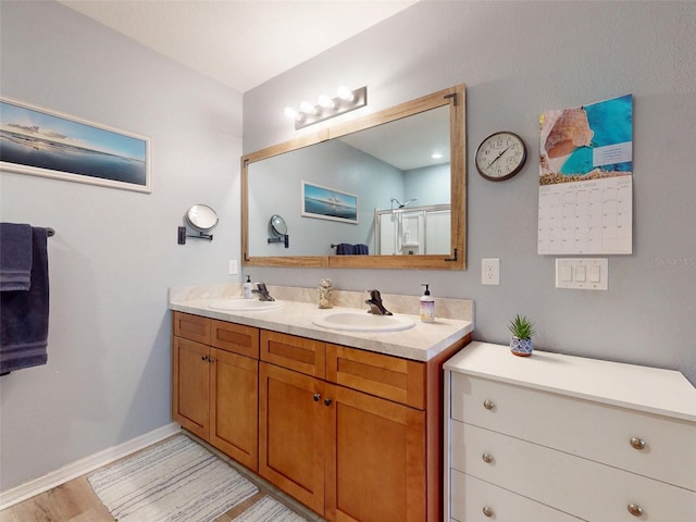 2731 Star Coral Ln, New Smyrna Beach, FL 32168 - full bathroom featuring double vanity, a shower stall, and wood finished floors