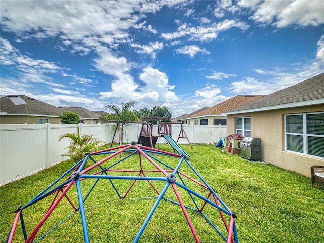 2731 Star Coral Ln, New Smyrna Beach, FL 32168 - fenced backyard featuring a playground