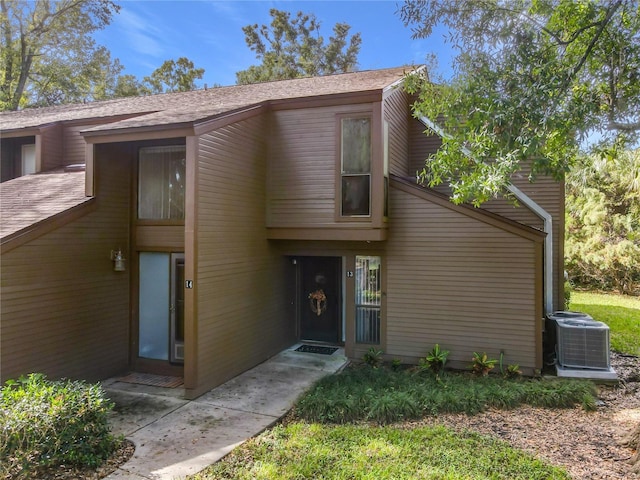 13 Surrey Ct Unit 13, Palm Coast, FL 32137 - doorway to property featuring roof with shingles
