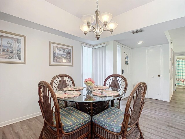 13 Surrey Ct Unit 13, Palm Coast, FL 32137 - dining space featuring a chandelier and light wood-type flooring