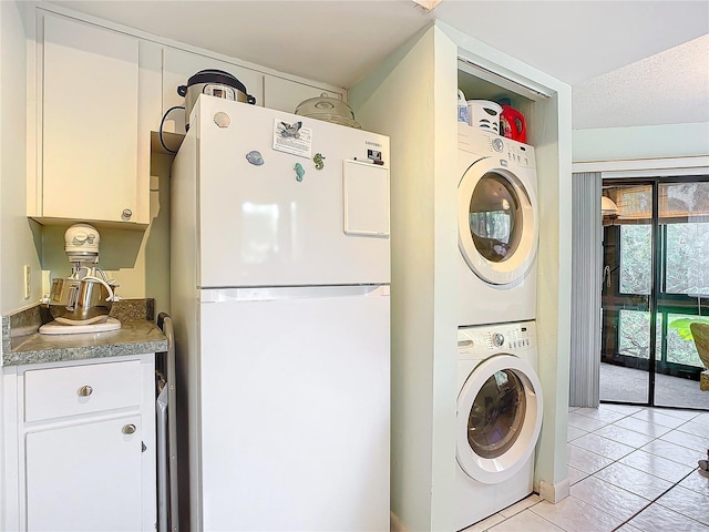 13 Surrey Ct Unit 13, Palm Coast, FL 32137 - laundry room featuring stacked washer and clothes dryer and light tile patterned floors