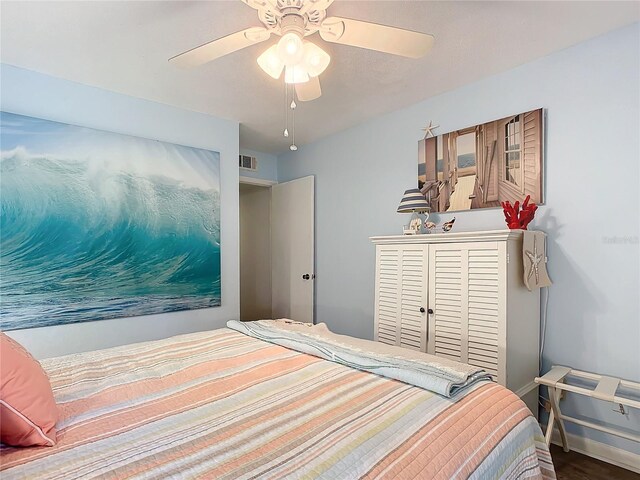 13 Surrey Ct Unit 13, Palm Coast, FL 32137 - bedroom with a ceiling fan and wood finished floors