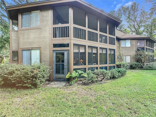 13 Surrey Ct Unit 13, Palm Coast, FL 32137 - rear view of property featuring a yard and a sunroom