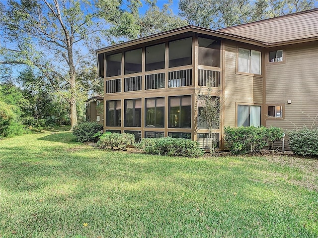 13 Surrey Ct Unit 13, Palm Coast, FL 32137 - back of property with a sunroom and a yard