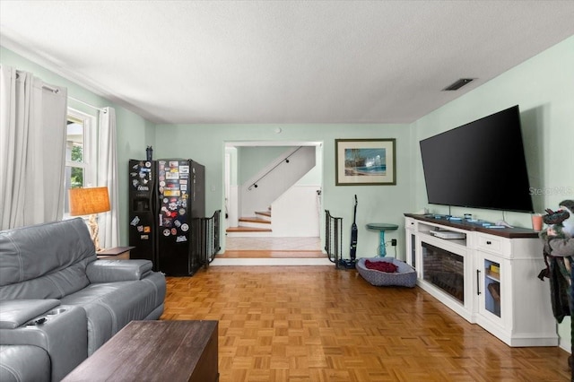 20 Putnam Ave, Ormond Beach, FL 32174 - living area with a textured ceiling and stairs