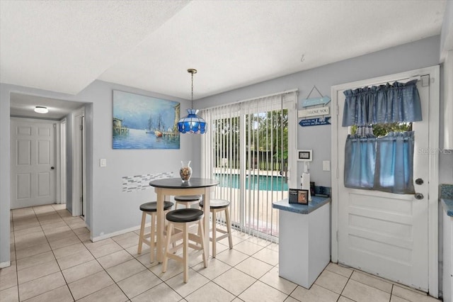 20 Putnam Ave, Ormond Beach, FL 32174 - dining area with light tile patterned floors and a textured ceiling