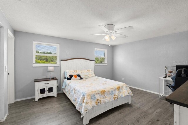 20 Putnam Ave, Ormond Beach, FL 32174 - bedroom featuring wood finished floors, a textured ceiling, and a ceiling fan