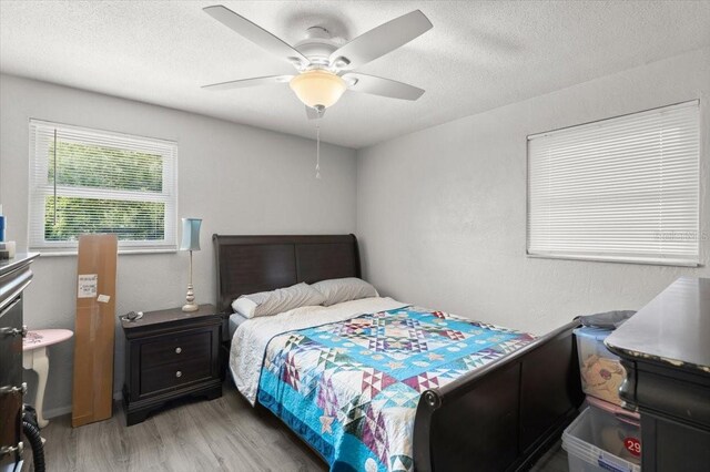 20 Putnam Ave, Ormond Beach, FL 32174 - bedroom featuring light wood-style flooring, a textured ceiling, and a ceiling fan