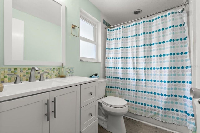 20 Putnam Ave, Ormond Beach, FL 32174 - bathroom with vanity, tasteful backsplash, shower / bath combination with curtain, and wood finished floors