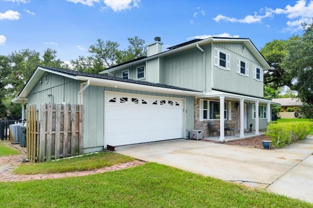 20 Putnam Ave, Ormond Beach, FL 32174 - view of front of property with a porch, driveway, an attached garage, a chimney, and board and batten siding