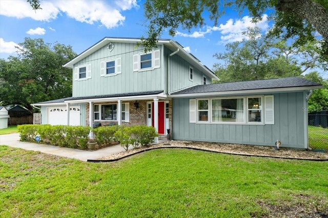 20 Putnam Ave, Ormond Beach, FL 32174 - traditional-style house with covered porch, concrete driveway, and a garage