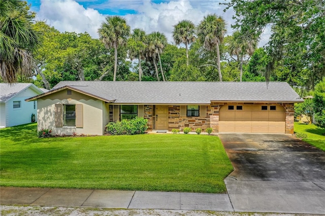 ranch-style home featuring an attached garage, driveway, a front lawn, a shingled roof, and stone siding