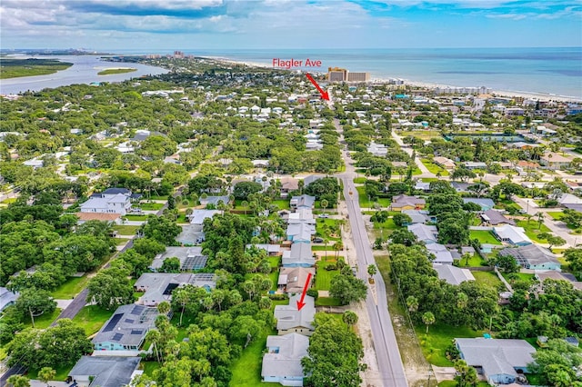 aerial view of property's location featuring a large body of water and nearby suburban area