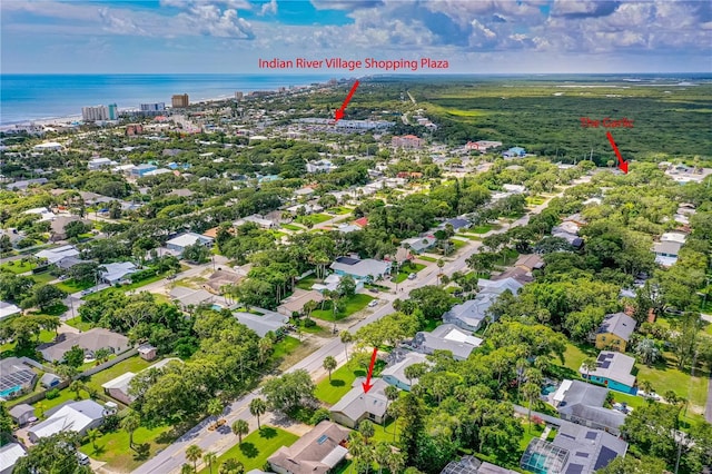 aerial view of property's location with a nearby body of water and nearby suburban area