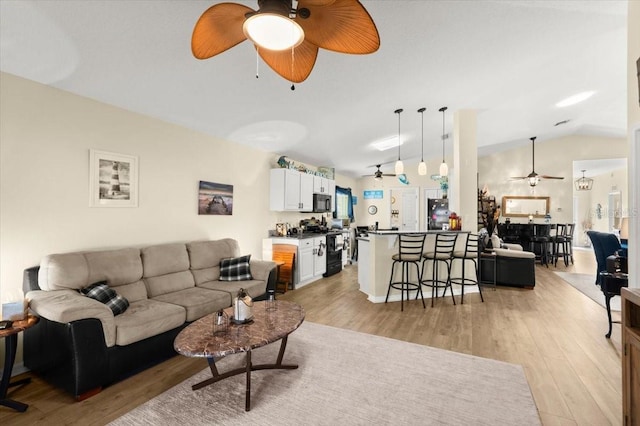 318 Two Oaks Dr, Edgewater, FL 32141 - living room featuring a ceiling fan, lofted ceiling, and light wood-style flooring