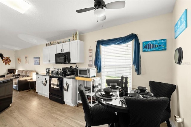 318 Two Oaks Dr, Edgewater, FL 32141 - kitchen with black appliances, open floor plan, light wood-type flooring, ceiling fan, and white cabinetry