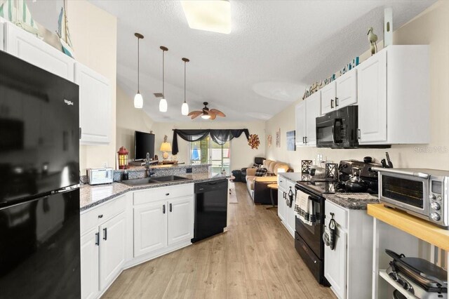 318 Two Oaks Dr, Edgewater, FL 32141 - kitchen featuring black appliances, open floor plan, light wood-style flooring, a peninsula, and ceiling fan