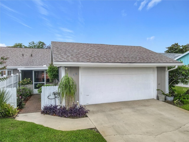 44 Fore Dr, New Smyrna Beach, FL 32168 - view of front of home featuring a shingled roof, a garage, and concrete driveway