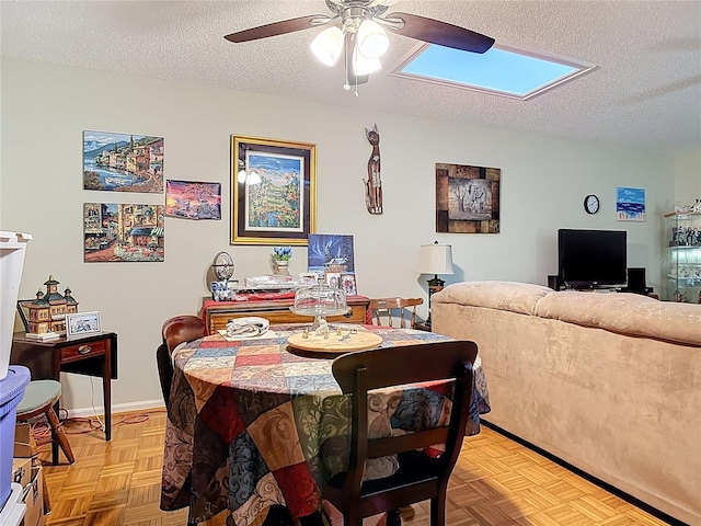 44 Fore Dr, New Smyrna Beach, FL 32168 - dining area featuring a ceiling fan, a textured ceiling, and a skylight