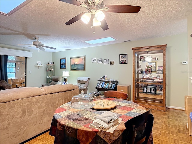 44 Fore Dr, New Smyrna Beach, FL 32168 - dining area with a skylight, a ceiling fan, and a textured ceiling