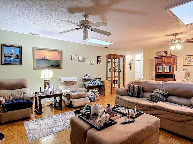 44 Fore Dr, New Smyrna Beach, FL 32168 - living room featuring a skylight, a ceiling fan, and a textured ceiling
