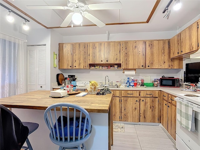 44 Fore Dr, New Smyrna Beach, FL 32168 - kitchen with black microwave, white range with electric stovetop, butcher block counters, a kitchen bar, and light tile patterned floors