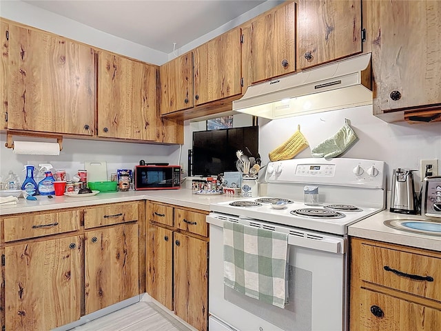 44 Fore Dr, New Smyrna Beach, FL 32168 - kitchen featuring white electric range, black microwave, under cabinet range hood, and light countertops