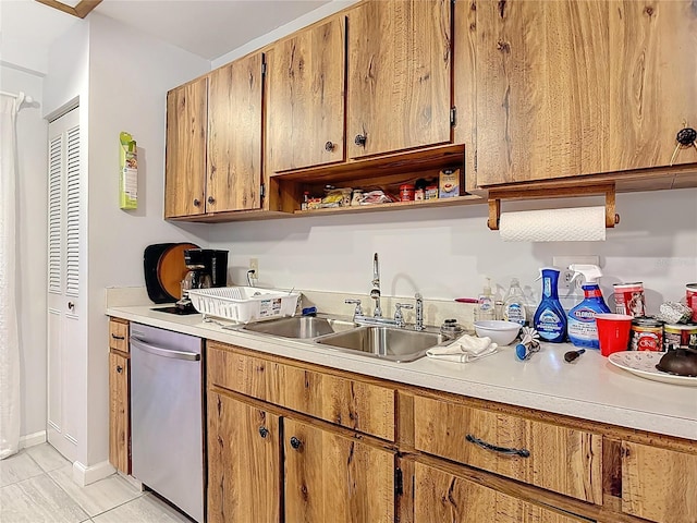 44 Fore Dr, New Smyrna Beach, FL 32168 - kitchen with stainless steel dishwasher, light countertops, light tile patterned flooring, open shelves, and brown cabinetry