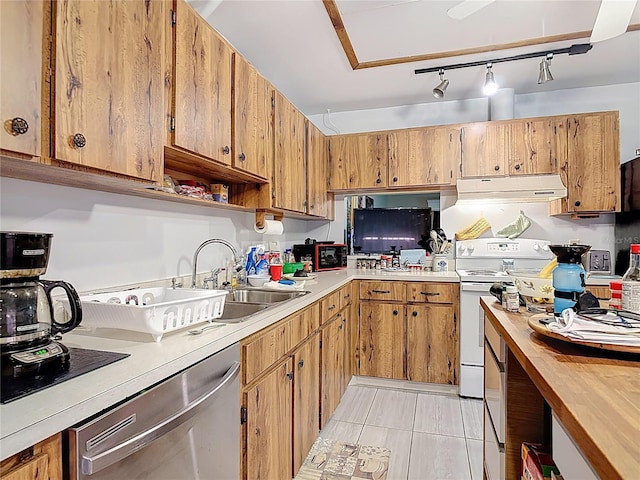44 Fore Dr, New Smyrna Beach, FL 32168 - kitchen with dishwasher, under cabinet range hood, electric stove, brown cabinets, and light tile patterned flooring