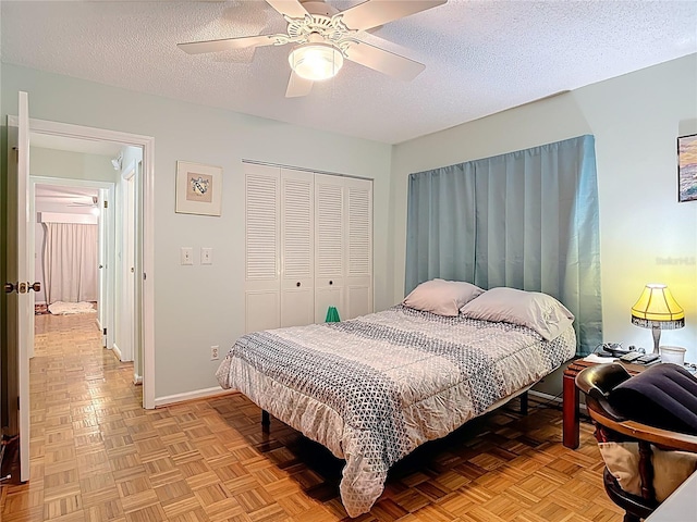 44 Fore Dr, New Smyrna Beach, FL 32168 - bedroom with a closet, a textured ceiling, and a ceiling fan