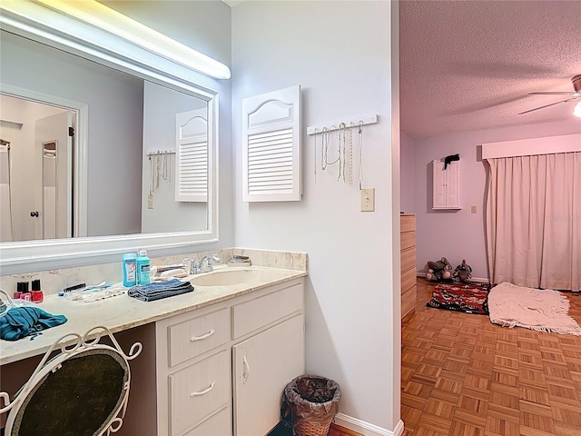 44 Fore Dr, New Smyrna Beach, FL 32168 - bathroom featuring a textured ceiling, vanity, and ceiling fan