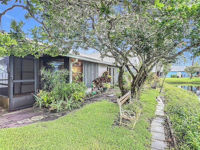 44 Fore Dr, New Smyrna Beach, FL 32168 - view of green lawn featuring a water view and a sunroom