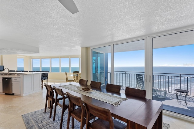 2625 S Atlantic Ave Unit 28Se, Daytona Beach Shores, FL 32118 - dining area with a textured ceiling and a water view