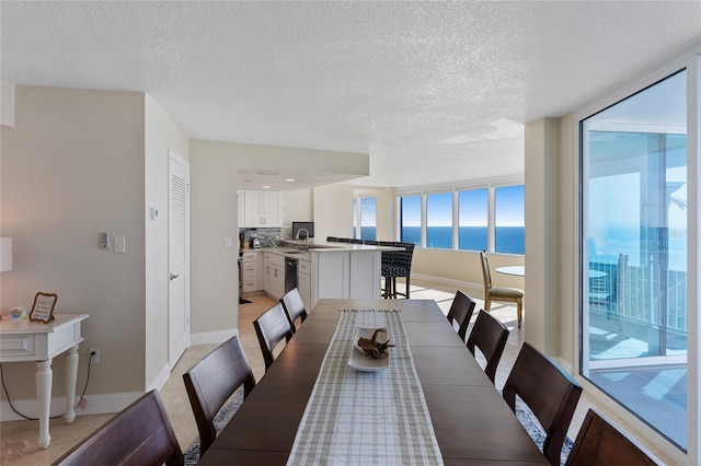 2625 S Atlantic Ave Unit 28Se, Daytona Beach Shores, FL 32118 - dining space with a textured ceiling and a water view