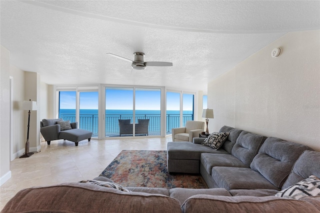 2625 S Atlantic Ave Unit 28Se, Daytona Beach Shores, FL 32118 - living area featuring a water view, ceiling fan, and a textured ceiling