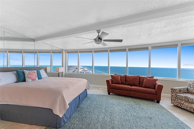 2625 S Atlantic Ave Unit 28Se, Daytona Beach Shores, FL 32118 - bedroom with a water view, ceiling fan, and multiple windows