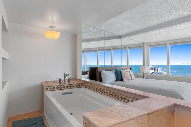 2625 S Atlantic Ave Unit 28Se, Daytona Beach Shores, FL 32118 - ensuite bathroom with a water view, a bath, and tile patterned floors