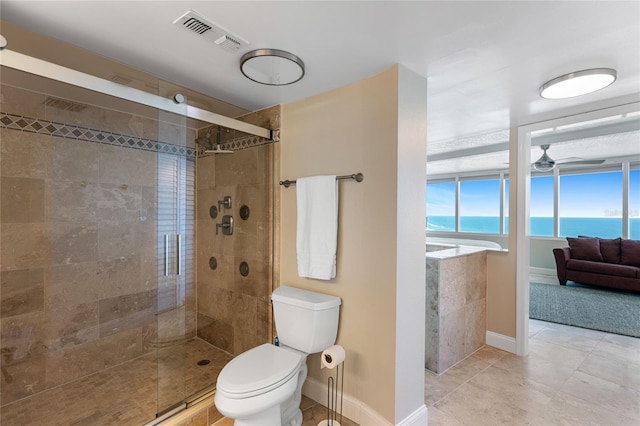 2625 S Atlantic Ave Unit 28Se, Daytona Beach Shores, FL 32118 - bathroom featuring a shower stall, tile patterned flooring, ceiling fan, and a water view