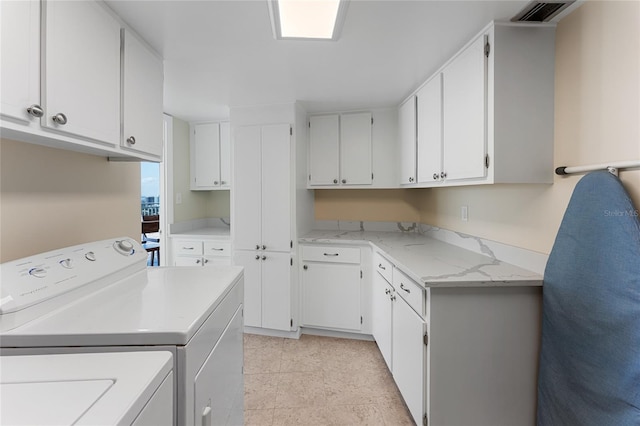 2625 S Atlantic Ave Unit 28Se, Daytona Beach Shores, FL 32118 - laundry area with cabinet space, washer and dryer, and light tile patterned floors
