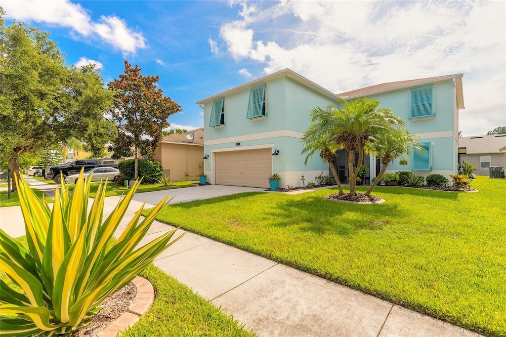 509 Aeolian Dr, New Smyrna Beach, FL 32168 - view of front facade with stucco siding, an attached garage, driveway, and a front lawn
