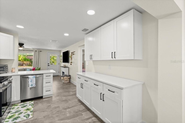 129 Rogers Pl, Port Orange, FL 32127 - kitchen with appliances with stainless steel finishes, white cabinets, recessed lighting, light countertops, and ceiling fan